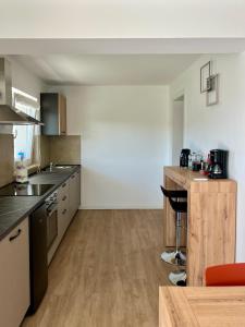 a large kitchen with a counter and a table at Casa Luca in Garda