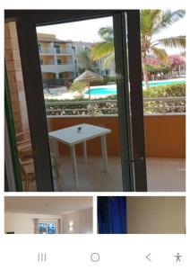 a room with a table and a view of a pool at Ground floor Studio Vila Verde in Prainha
