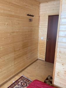 a room with a wooden wall and a door at Guest house River side in Adishi +81 photos