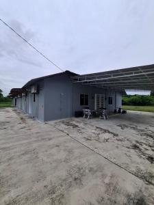 a large building with a large parking lot at Guesthouse Sungai Musoh in Pengerang +28 photos