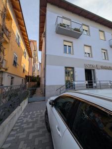 a white car parked in front of a building at Dietro l'Angolo in Millesimo