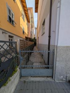 a stairway between two buildings with a gate at Dietro l'Angolo in Millesimo