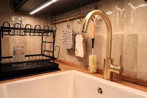a kitchen sink with a faucet next to a counter at Colosseo Garden Lodge in Rome +80 photos