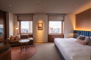 a hotel room with a bed and a couch at The Mark Grand Hotel in Saitama +62 photos
