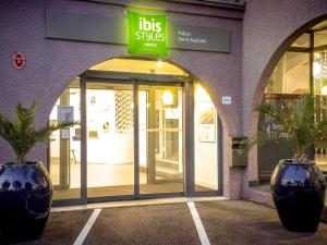 a store front with two potted plants in front of it at ibis Styles Fréjus St Raphael in Fréjus