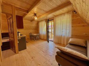a living room with a bed and a dining room at Lakarido in Tsesi +12 photos