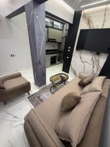 a bedroom with a bed and a tv and a couch at Happy apartment 3 in Cairo