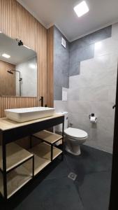 a bathroom with a sink and a toilet and a mirror at Black Sea Pearl in Krapets +120 photos