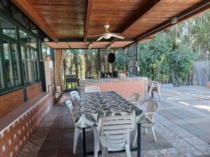a table and chairs on a patio with a ceiling at Spacious Garden Villa, private pool, huge grounds with orange trees in Dos Hermanas