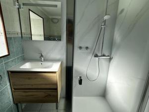 a white bathroom with a sink and a shower at Gîte campagne et clim - 4 pers. - FR-1-489-84 in Saint-Bonnet-Tronçais +22 photos
