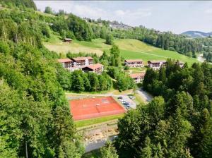 an aerial view of a resort with a tennis court at Luxus Chalet in Oberstaufen inkl Wellness Pool und Bergbahnen in Oberstaufen