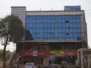 a large glass building on a city street at Hotel The Skyluxe in Agra