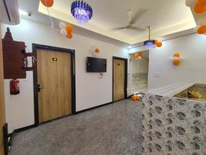 a room with two doors and a television on the wall at Hotel The Skyluxe in Agra