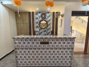 a lobby with a counter with a sign on a wall at Hotel The Skyluxe in Agra