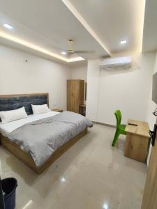 a bedroom with a bed and a tv and a table at Hotel The Skyluxe in Agra +24 photos