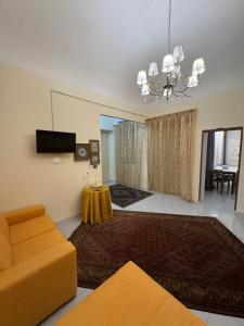 a living room with a couch and a chandelier at House S&D in Giarre