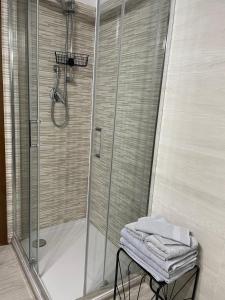 a shower with a glass door in a bathroom at B&B Fiume in Morino