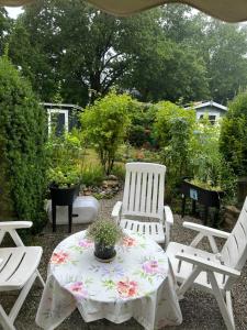 a patio with two white chairs and a table with a flower pattern at aba ZARA in Hamburg
