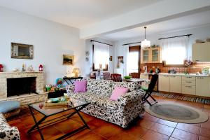a living room with a couch and a fireplace at Zeusplace Lemon Villa in Korinos