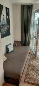 a large bed in a room with a window at Apartmán Hodoňovice in Frýdek-Místek