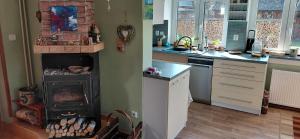 a kitchen with a stove in the corner of a kitchen at Apartmán Hodoňovice in Frýdek-Místek +9 photos