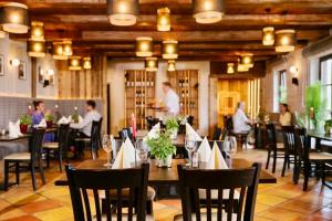 a restaurant with people sitting at tables in a room at Luxus Chalet in Oberstaufen inkl Wellness Pool und Bergbahnen in Oberstaufen