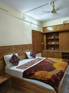 a bedroom with a bed with a blanket on it at Third eye view hotel and hostel in Jaisalmer