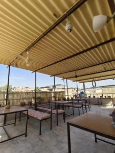 a group of tables and benches on a patio at Third eye view hotel and hostel in Jaisalmer