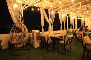 a restaurant with a table and chairs with a view at Hotel Krishna Residency in Udaipur