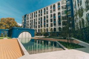 a building with a pool of water in front of a building at Above Element Bangtao Phuket by Arthouse Collection in Laguna Phuket
