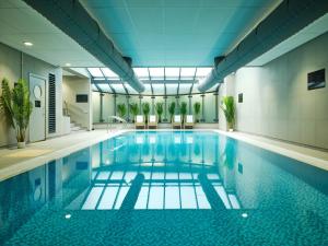 a large swimming pool in a building at The Milner York in York