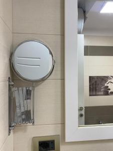 a mirror on the wall of a bathroom at Redi Apartment Center in Elbasan