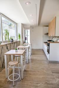 a kitchen with tables and chairs in a room at My Place B&B in Carini