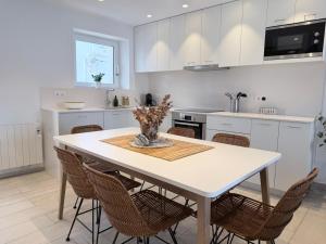 a kitchen with a white table and chairs at POAL-Dúplex de ensueño en Cadaqués in Cadaqués