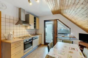 a kitchen with a table and a dining room at Ferienwohnung Ettenheim in Ettenheim