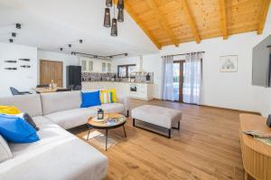 a living room with a couch and a table at Villa STOCK 66 by Villsy in Štokovci