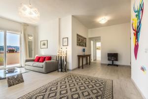 a living room with a couch and a tv at Elafi Penthouse in Cagliari