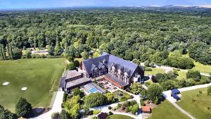 an aerial view of a large house with a pool at Domaine de la Forêt d'Orient, Logis Hôtel, Restaurant, Spa et Golf in Rouilly-Sacey