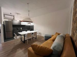 a living room and kitchen with a couch and a table at Art Residency Borgo Castello in Gorizia +4 photos
