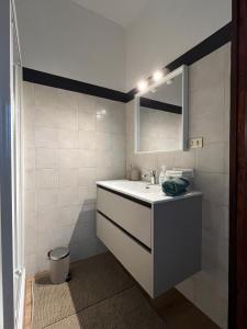 a bathroom with a sink and a mirror at Art Residency Borgo Castello in Gorizia