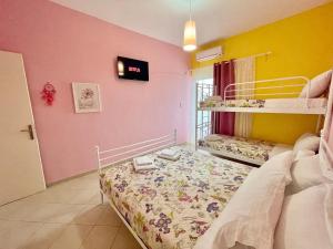 a bedroom with two bunk beds in a room at FLY, Oneiropagida, Aegina in Vathí