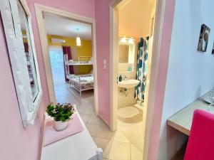a small bathroom with a sink and a toilet at FLY, Oneiropagida, Aegina in Vathí