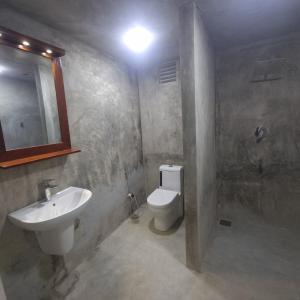 a bathroom with a sink and a toilet and a mirror at Shells By D in Negombo +13 photos