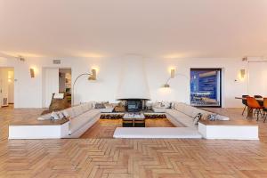 a living room with white furniture and a fireplace at Casa del Capitan in Cadaqués