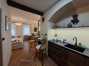 a kitchen and living room with a sink and a table at Old Town Living Studio in Český Krumlov