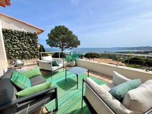 a patio with couches and a table on a balcony at Villa Horizon Bleu in Sainte-Maxime