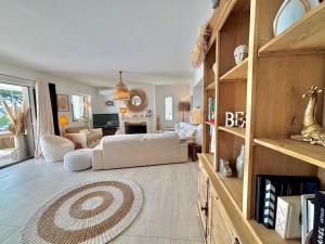 a living room with a white couch and a table at Villa Horizon Bleu in Sainte-Maxime