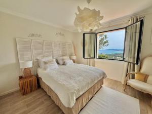 a bedroom with a large bed and a large window at Villa Horizon Bleu in Sainte-Maxime