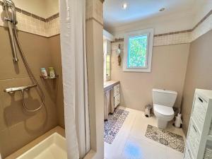 a bathroom with a shower and a toilet and a sink at Villa Horizon Bleu in Sainte-Maxime +21 photos