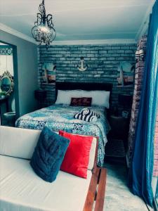 a bedroom with a bed with a red pillow on a bench at Ocean gate in Hartbeespoort